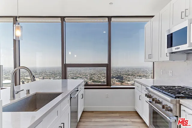 a kitchen with a sink stove top oven and refrigerator