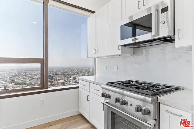 a white stove top oven sitting inside of a kitchen