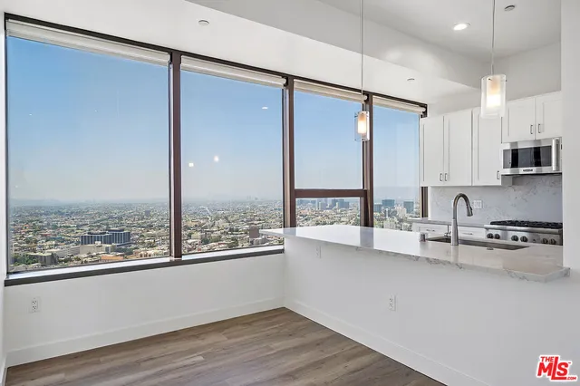 a kitchen with stainless steel appliances a sink and a large window