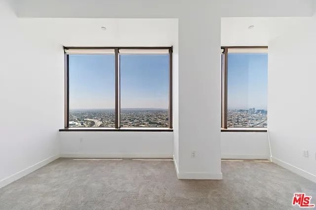 an empty room with windows and closet