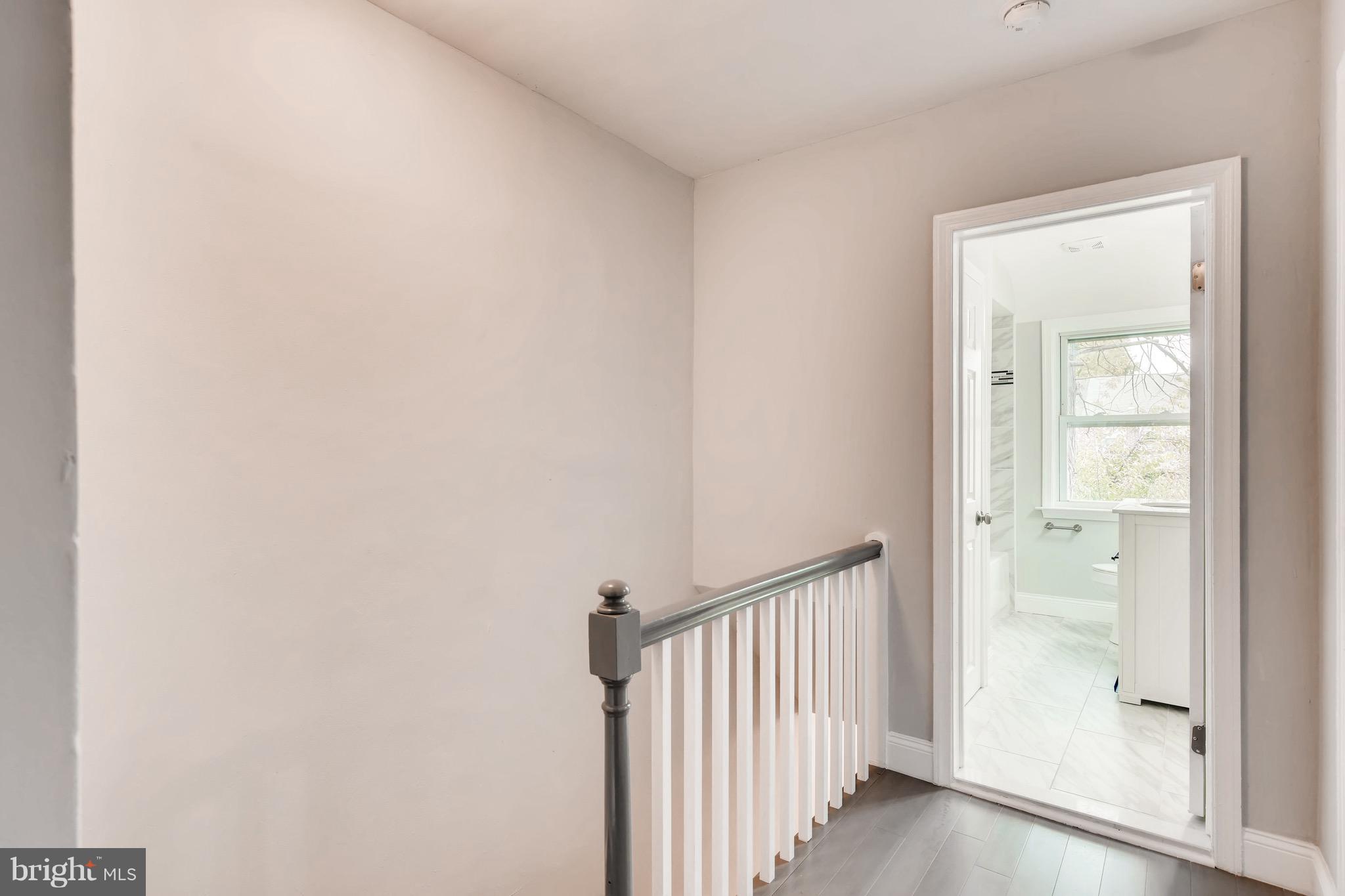 1315 Silverthorne Road Baltimore, MD 21239 - Photo 18 of 28 a view of a hallway with a wooden floor