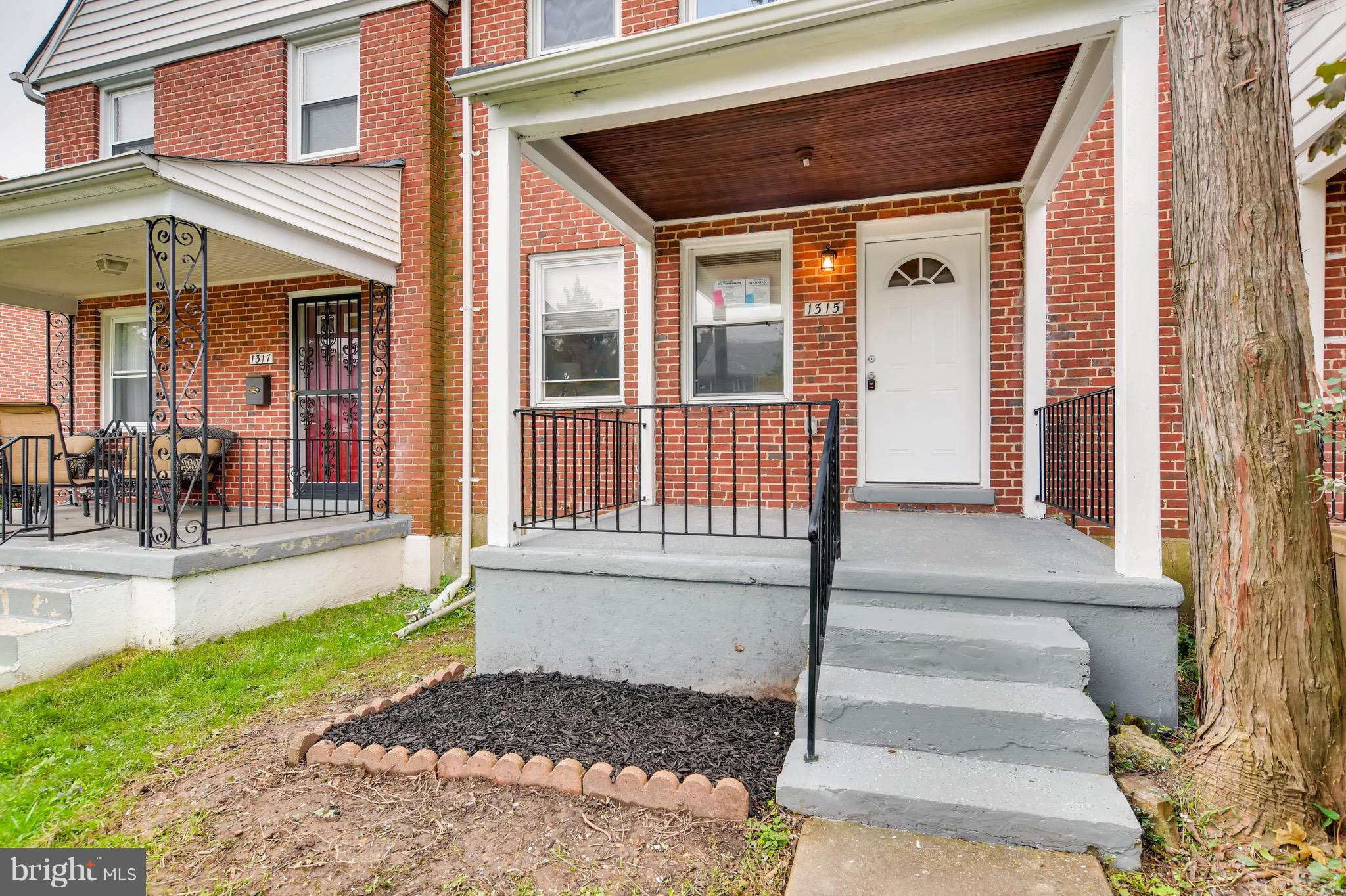 1315 Silverthorne Road Baltimore, MD 21239 - Photo 23 of 28 a front view of a house with a porch