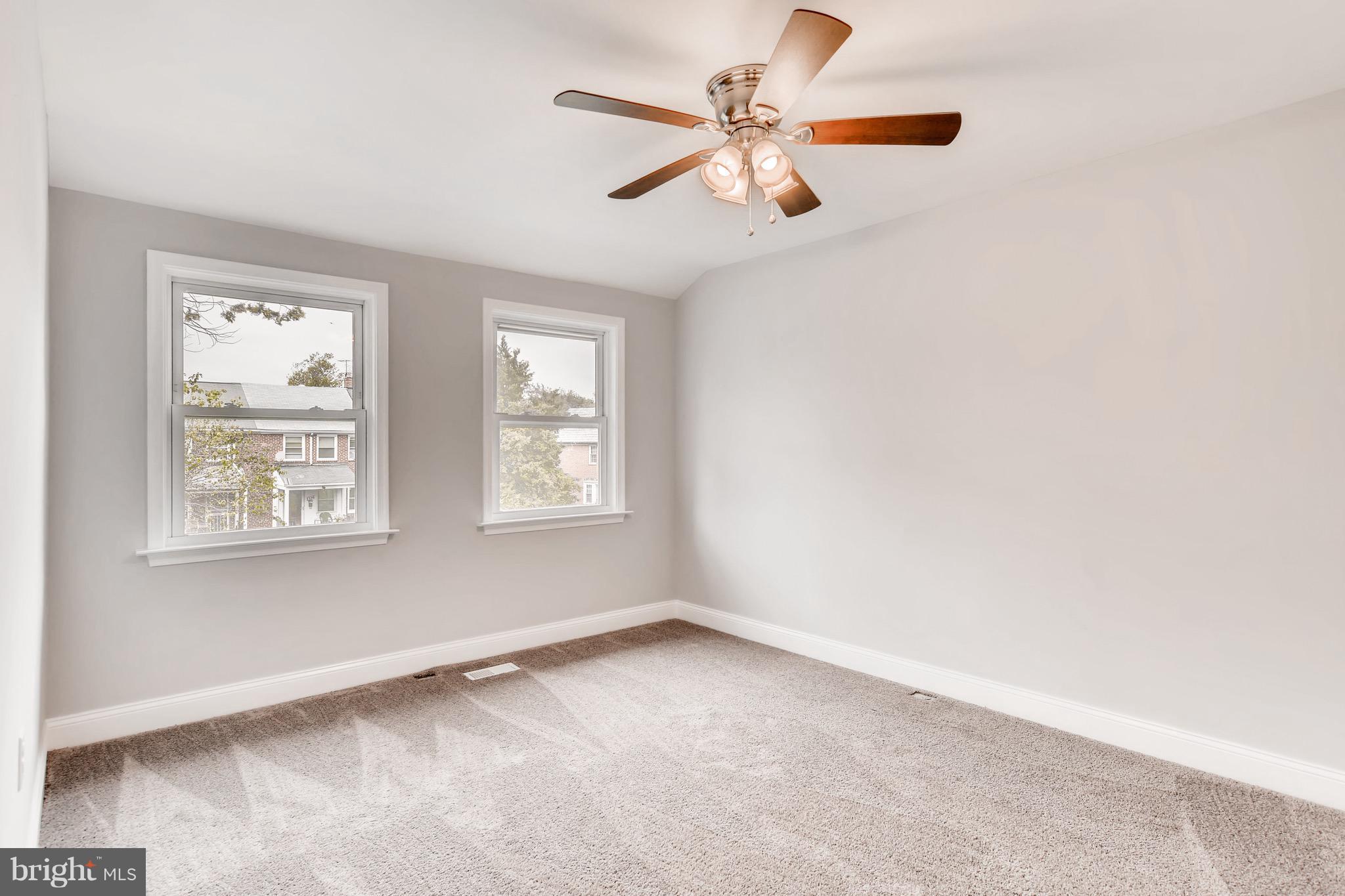 1315 Silverthorne Road Baltimore, MD 21239 - Photo 9 of 28 an empty room with a window and a fan