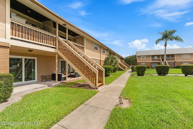 a view of a garden with large trees