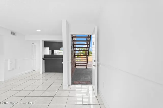 a view of a kitchen with furniture and an empty room