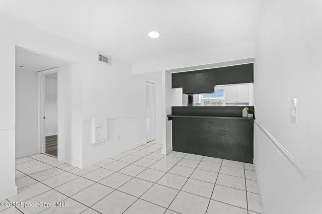 a view of kitchen with sink electronic appliances and window