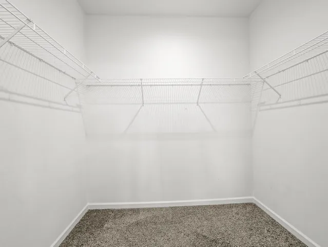 a view of a livingroom with a ceiling fan and window