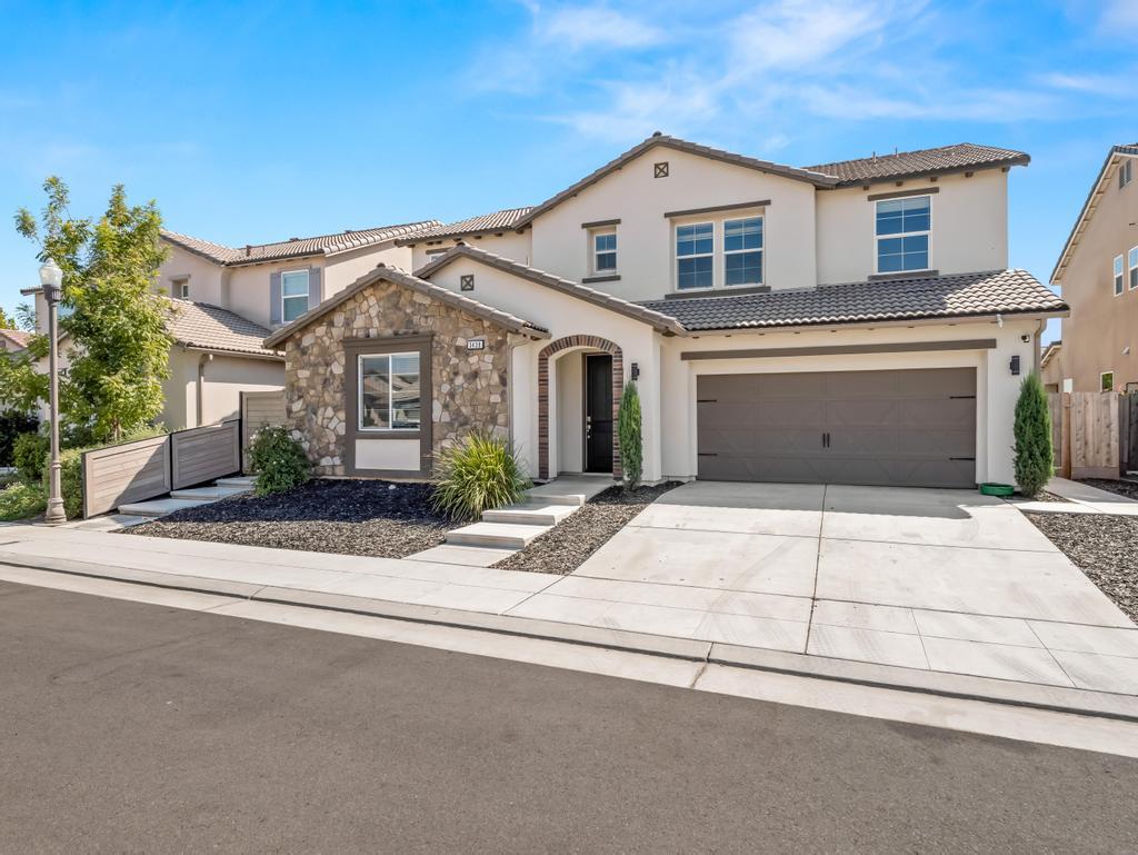 3438 Lincoln Avenue Clovis, CA 93619 - Photo 3 of 52 a front view of a house with a yard and garage