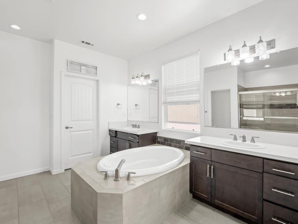 3438 Lincoln Avenue Clovis, CA 93619 - Photo 31 of 52 a bathroom with a tub sink double vanity and mirror