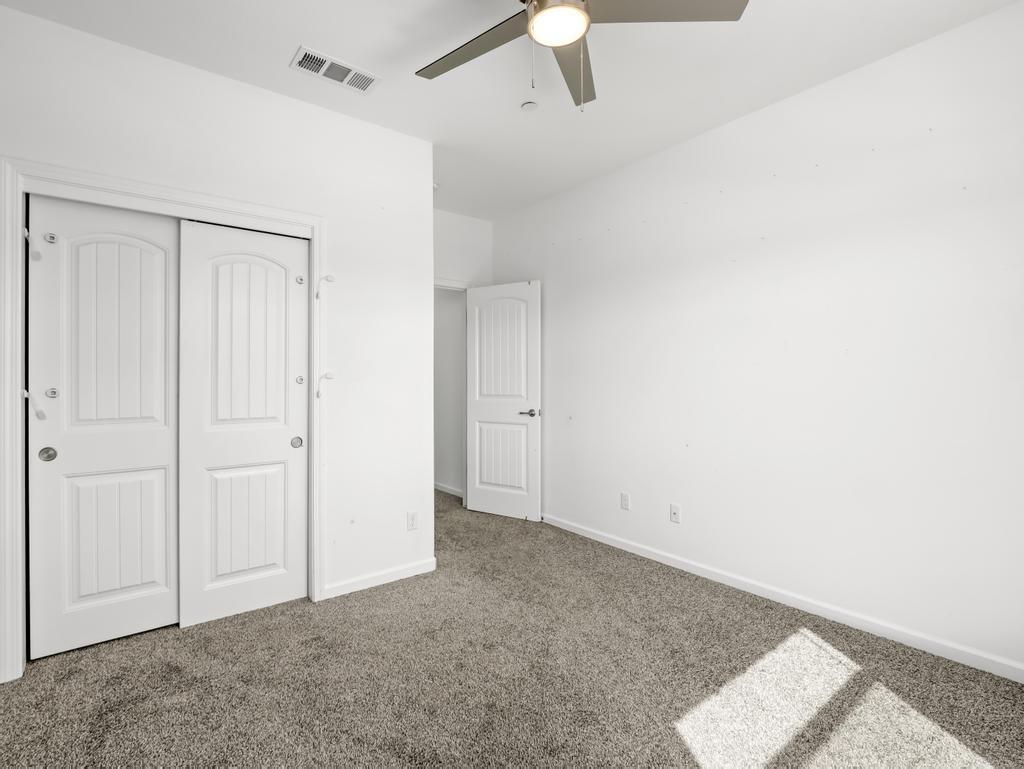 3438 Lincoln Avenue Clovis, CA 93619 - Photo 35 of 52 an empty room with a ceiling fan and carpet