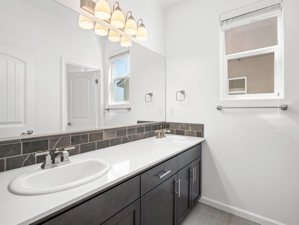 3438 Lincoln Avenue Clovis, CA 93619 - Photo 36 of 52 a bathroom with a sink a vanity and a mirror