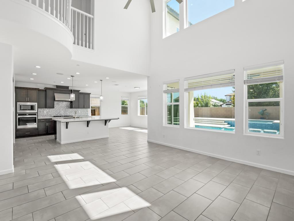 3438 Lincoln Avenue Clovis, CA 93619 - Photo 8 of 52 a large white kitchen with a large window and stainless steel appliances