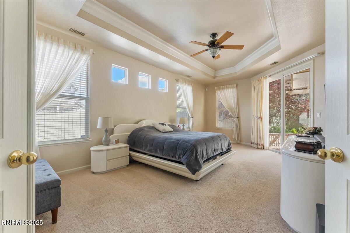 1556 Diamond Country Drive Reno, NV 89521 - Photo 6 of 29 a spacious bedroom with a bed and a chandelier