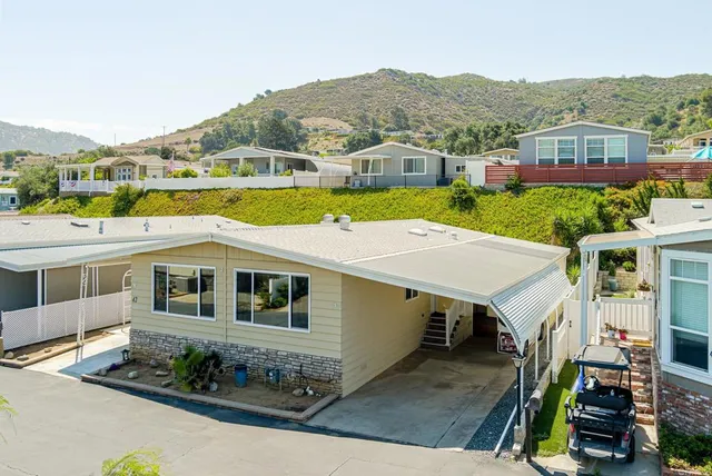 a aerial view of a house with a swimming pool and a yard