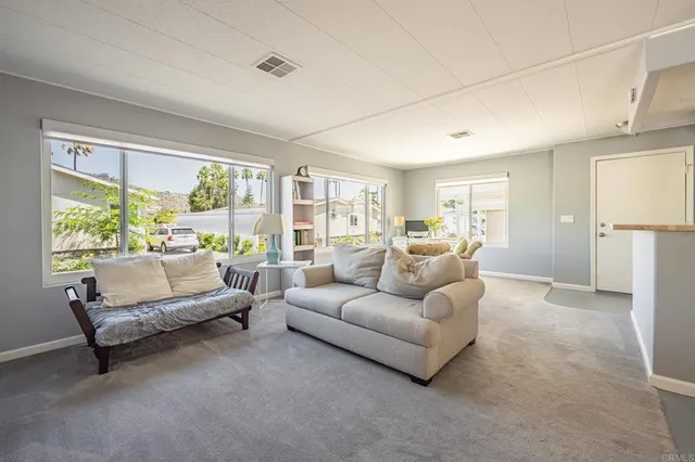 a living room with furniture a dining table and chairs with wooden floor