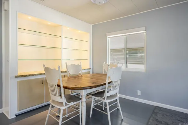 a kitchen with granite countertop a refrigerator sink and cabinets