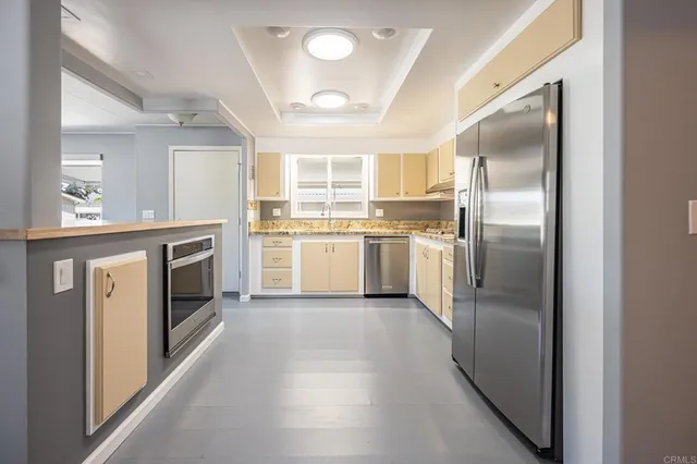 a stove top oven sitting inside of a kitchen