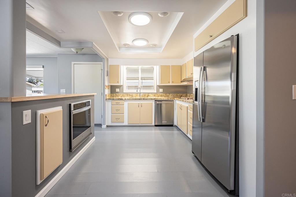 4650 Dulin Road, Unit 42 Fallbrook, CA 92003 - Photo 18 of 45 a kitchen with a stove sink and refrigerator