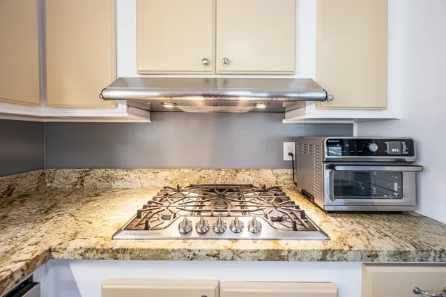 a kitchen with granite countertop a sink and a window
