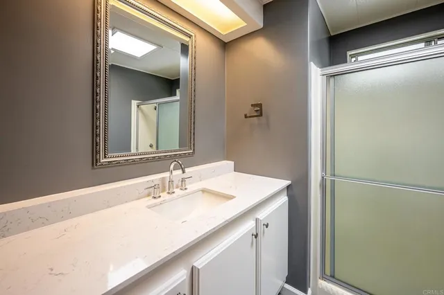 a bathroom with a shower and a sink
