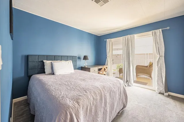 a bedroom with a bed and a chair