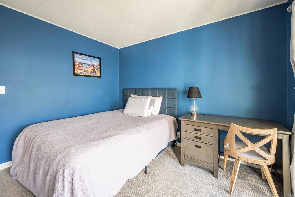 4650 Dulin Road, Unit 42 Fallbrook, CA 92003 - Photo 25 of 45 a bedroom with a bed and a chair