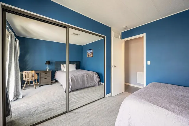 a bedroom with a large bed and a window