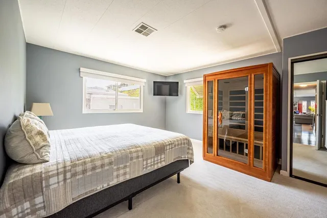 a bedroom with a bed and a window