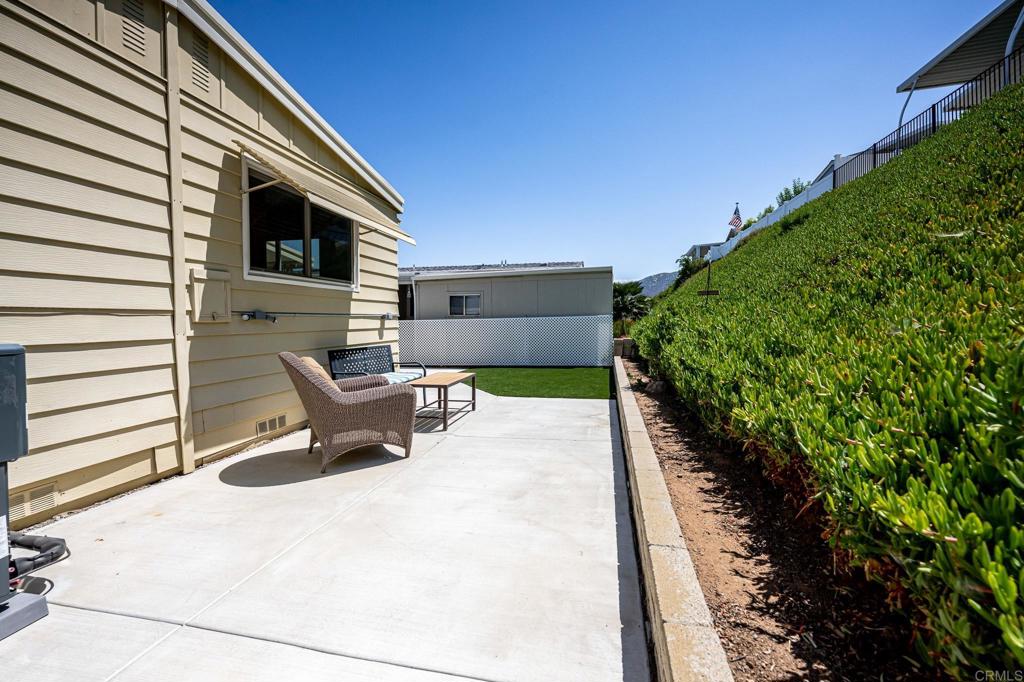 4650 Dulin Road, Unit 42 Fallbrook, CA 92003 - Photo 35 of 45 a roof deck with table and chairs and potted plants