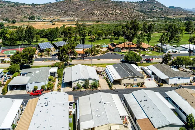 an aerial view of a residential houses with outdoor space and street view