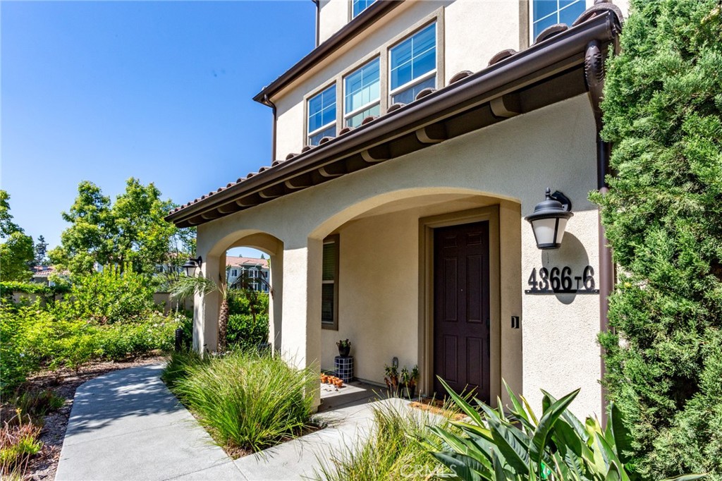 4366 Pacifica Way, Unit 6 Oceanside, CA 92056 - Photo 1 of 25 a front view of a house with a garden
