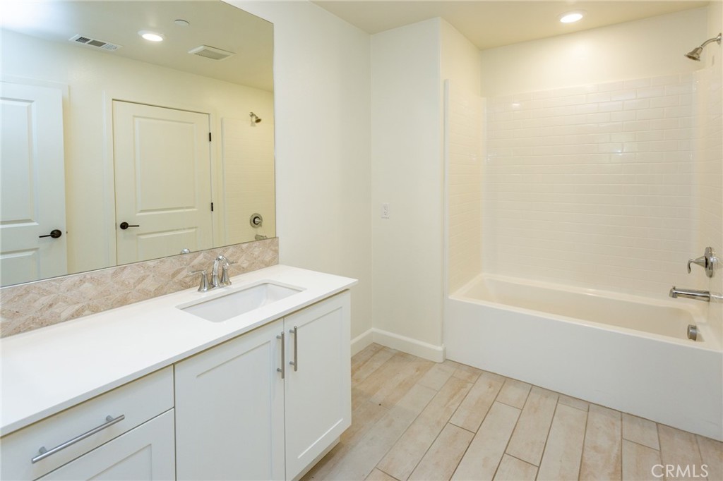 4366 Pacifica Way, Unit 6 Oceanside, CA 92056 - Photo 14 of 25 a bathroom with a sink a mirror and a bathtub
