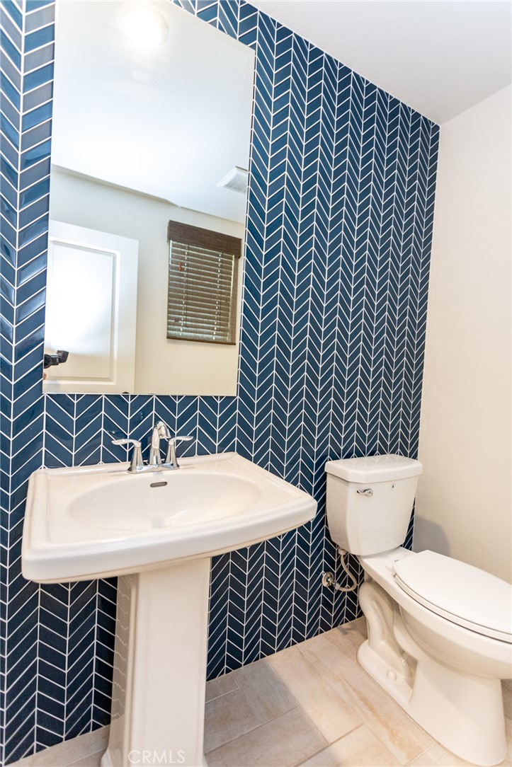 4366 Pacifica Way, Unit 6 Oceanside, CA 92056 - Photo 6 of 25 a bathroom with a sink toilet and mirror