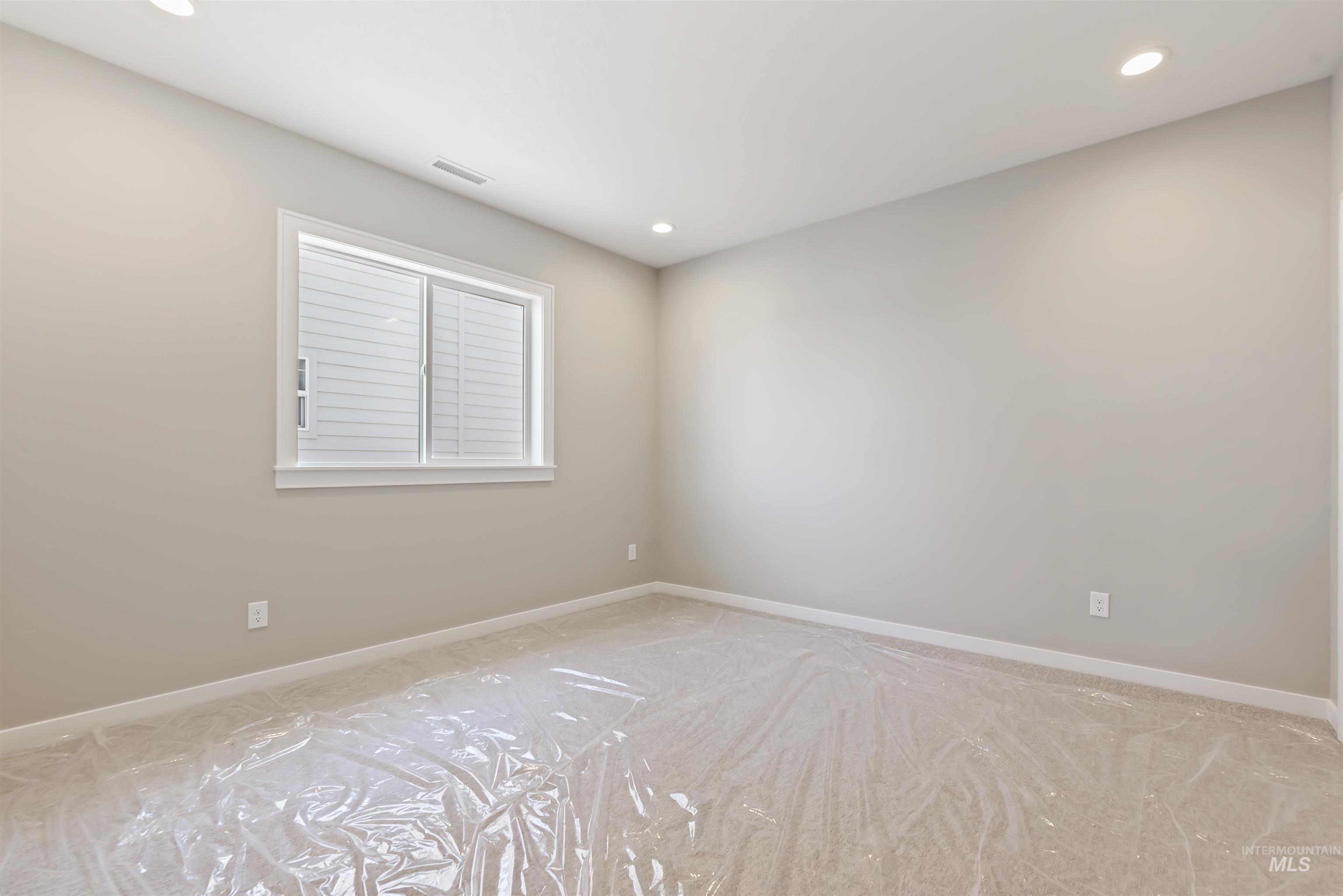 1935 West Bittern Street Nampa, ID 83686 - Photo 16 of 29 Empty room with recessed lighting and light carpet