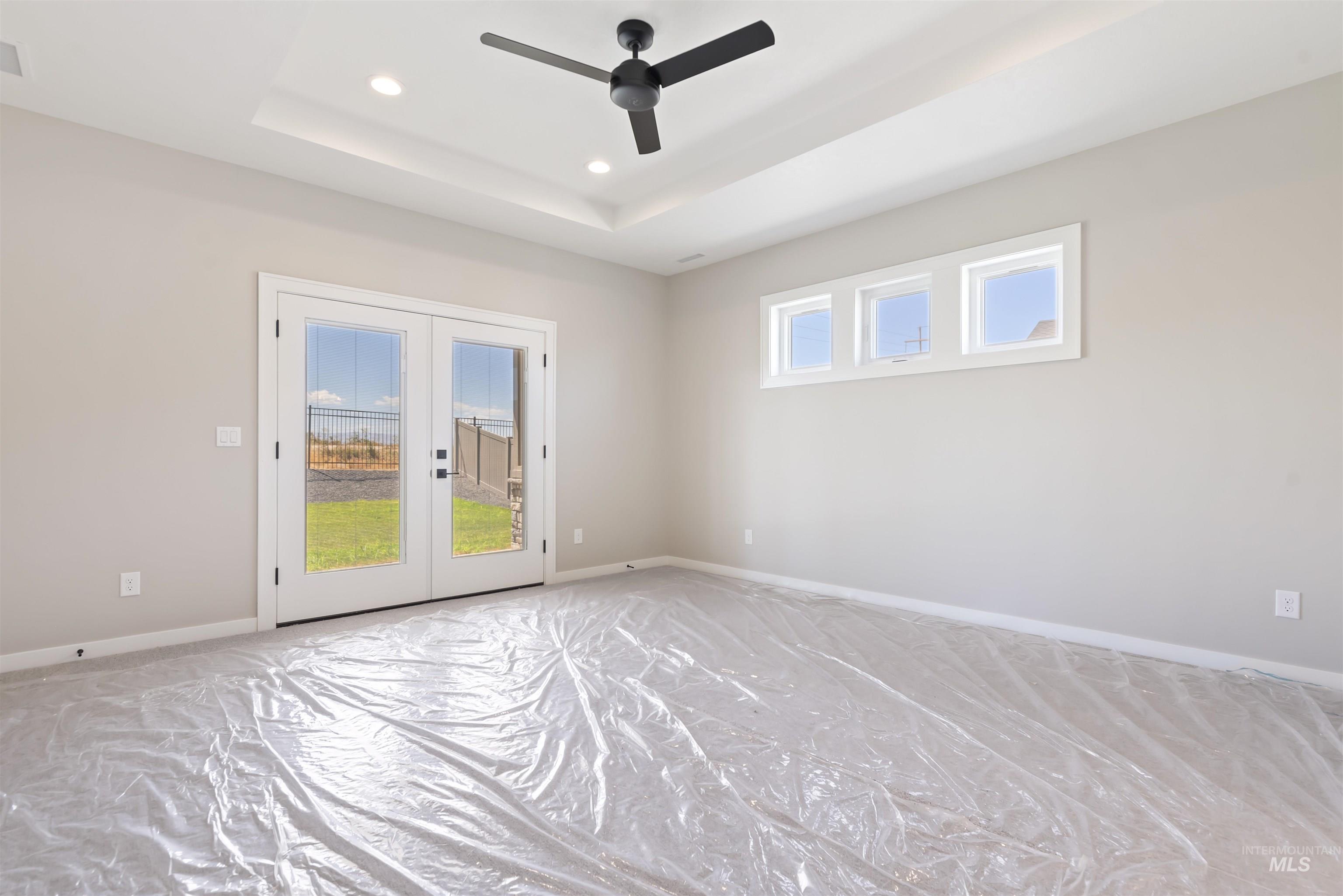 1935 West Bittern Street Nampa, ID 83686 - Photo 20 of 29 master bedroom with French doors, a raised ceiling, recessed lighting, and ceiling fan