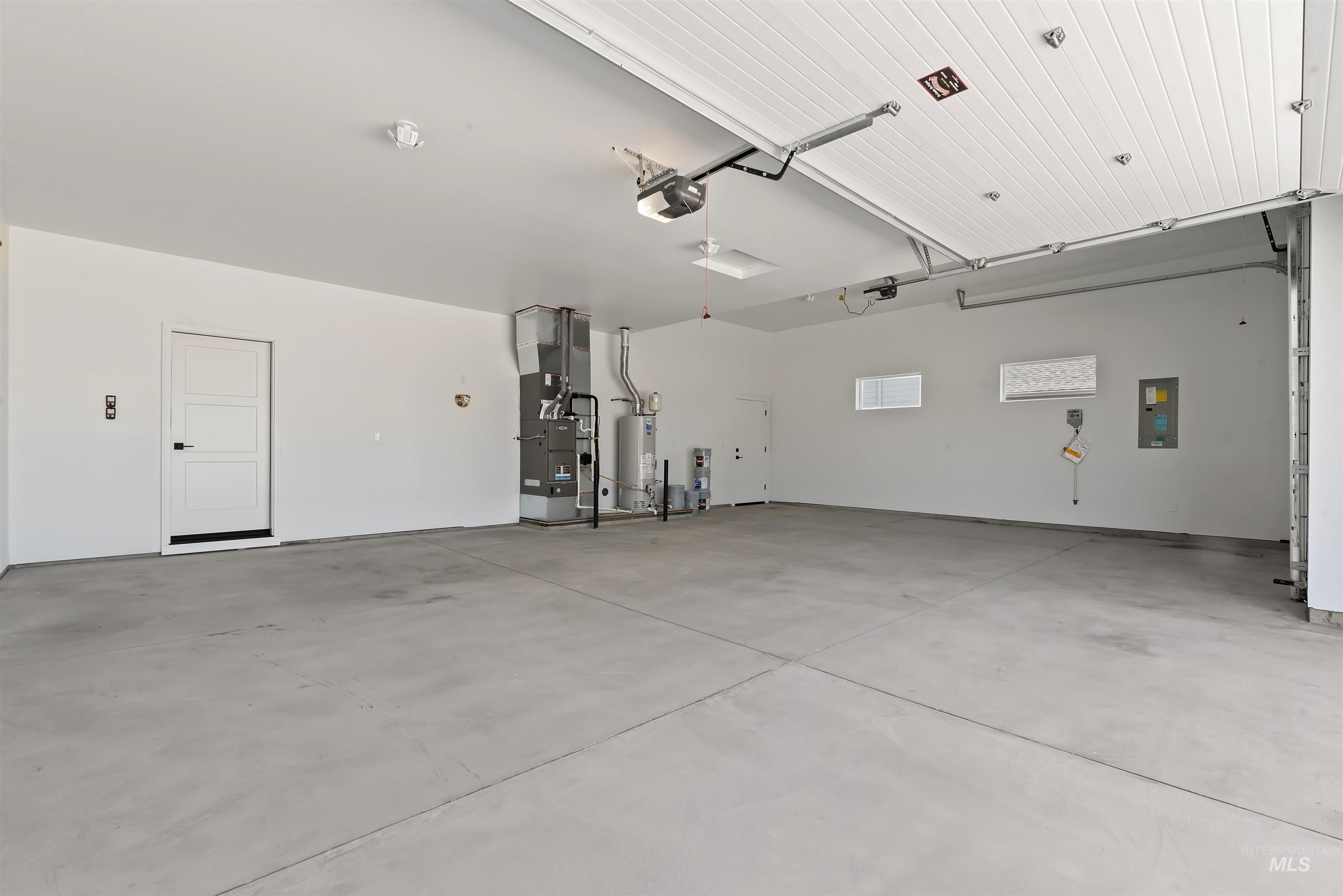 1935 West Bittern Street Nampa, ID 83686 - Photo 27 of 29 Garage with heating unit, electric panel, water heater, and a garage door opener