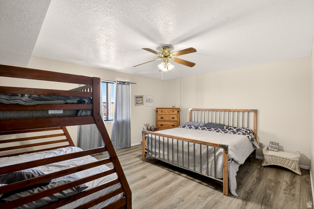 161 West 950 South, Unit Q1 St. George, UT 84770 - Photo 29 of 37 Bedroom featuring a textured ceiling, light wood-style floors, and ceiling fan