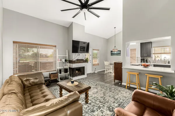 a living room with furniture a fireplace and a flat screen tv