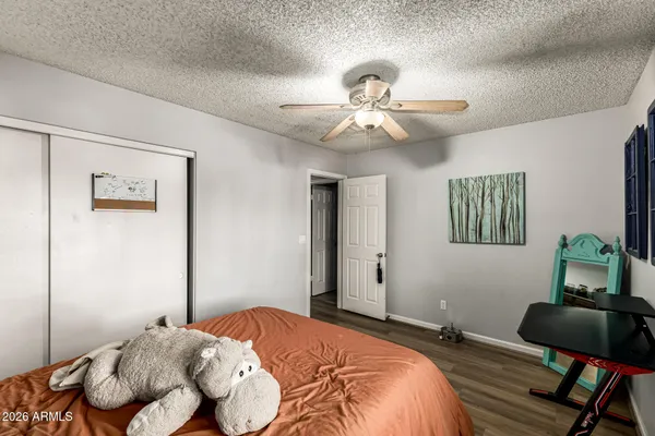 a bedroom with a bed and a chair