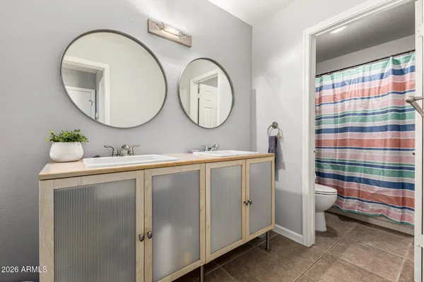 a bathroom with a double vanity sink and a mirror