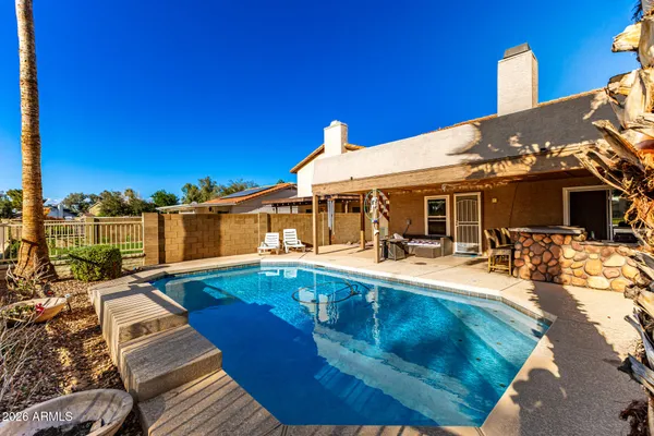 a view of a house with swimming pool and sitting area