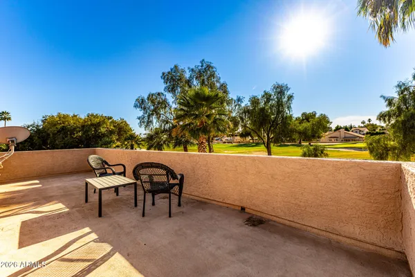 a view of a chairs and table in a backyard