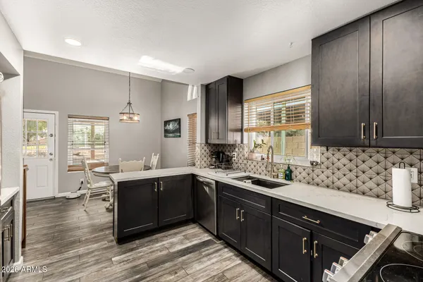 a kitchen with a sink and wooden cabinets