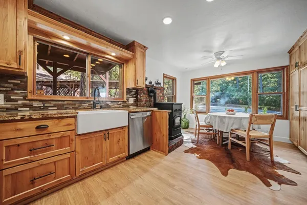a open kitchen with stainless steel appliances granite countertop a stove and cabinets