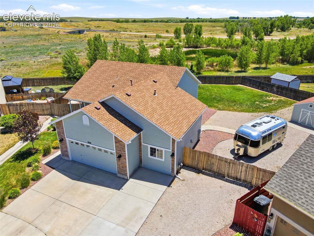 7806 Dutch Loop Colorado Springs, CO 80925 - Photo 32 of 41 an aerial view of a house with garden space and ocean view