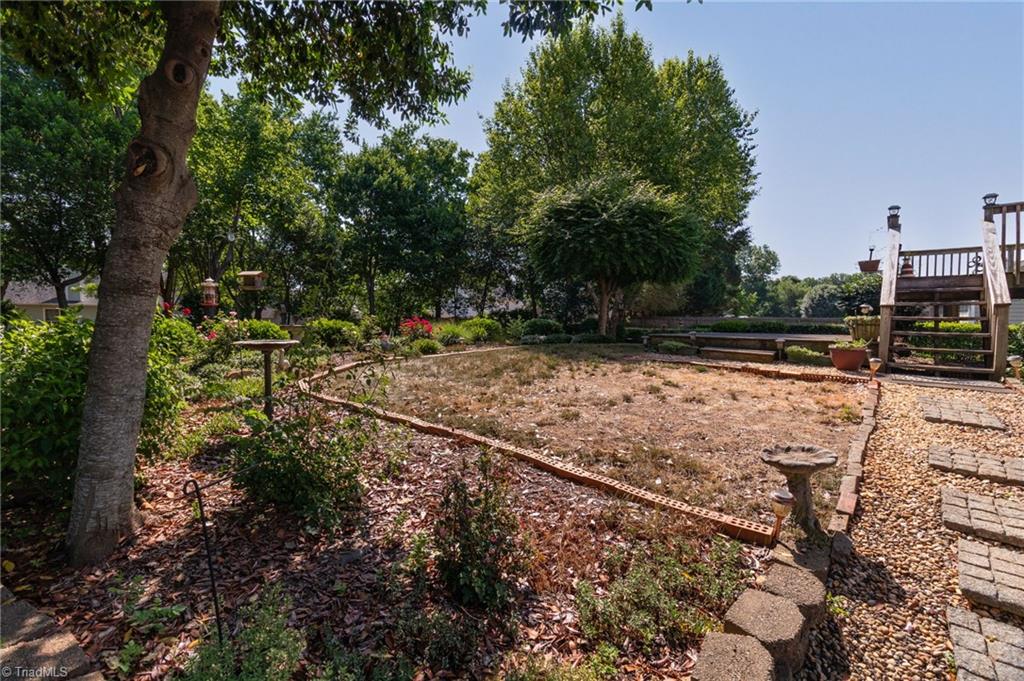 1735 Springfield Farm Court Clemmons, NC 27012 - Photo 24 of 30 Deck, wood patio, brick pavers on left side of back yard