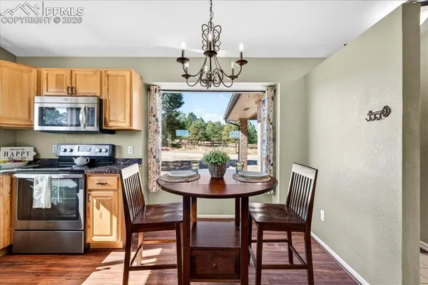 a view of a dining room with furniture window and wooden floor