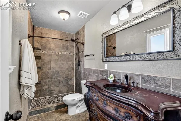 a bathroom with a sink a toilet and a shower