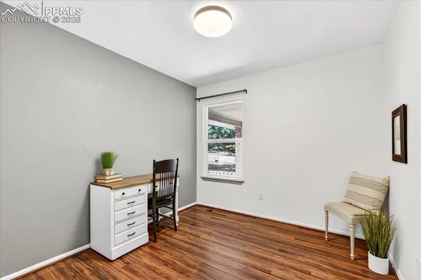 a workspace with furniture and wooden floor