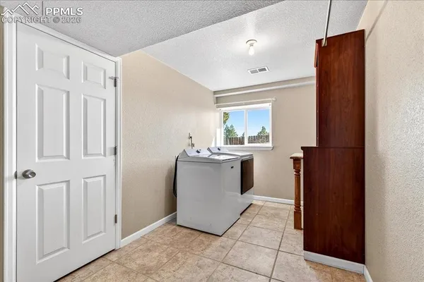 a view of a hallway with kitchen and entryway